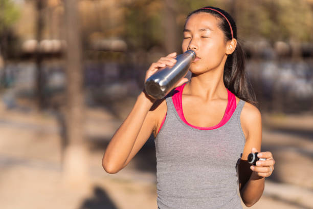 istock Young asian sportswoman taking a break after running 1445714105
