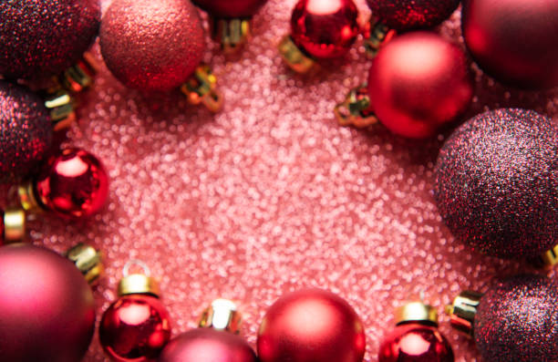 istock Red Christmas baubles  on red shiny background with copy space. 1445718550