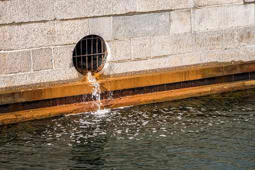 Drain water below street level flowing into the harbour in central Copenhagen.