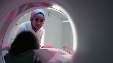 Woman nurse explaining the MRI scanning procedure to patient