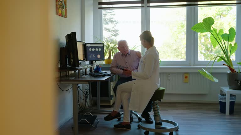 Neurologist discussing MRI scan results with senior man in clinic