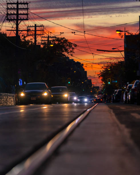 Toronto, Canada - October 23, 2022 : Rush hour traffic down Queen street during a vibrant sunset
