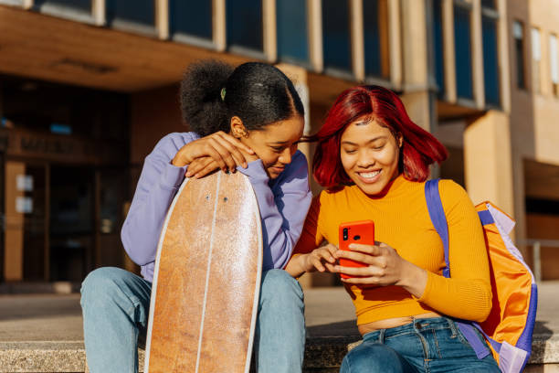 istock young girls using phone 1445725972
