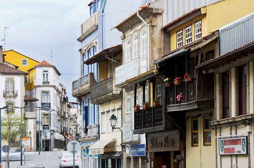 Chaves, Portugal- April 2, 2011: Row of  traditional houses, wooden balconies, stores, city life. Chaves, Portugal.