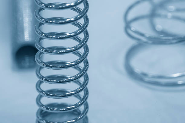istock Close up scene the wire coil spring in the light blue scene. 1445730313
