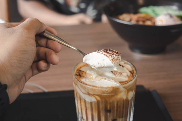 istock Close-up of hand scooping ice-cream latte 1445732017