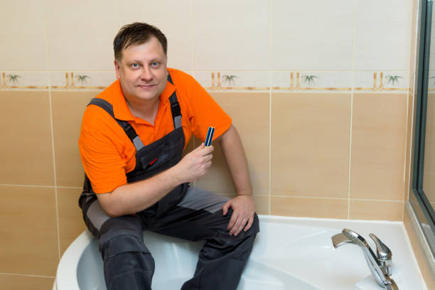 istock A man with a screwdriver sits on a large bathtub after renovation 1445735340