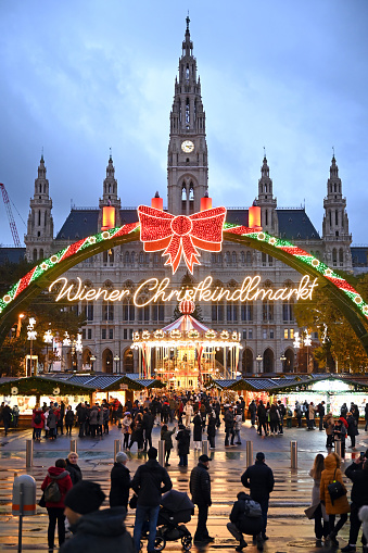 View of the illuminated Christmas market in front of the City Hall in Vienna, Austria, in the evening