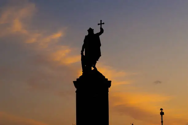 Silhouette of the King's Pelayo statue at sunset, near to the marina, Gijón, Asturias.