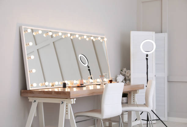 istock Modern mirror with light bulbs on dressing table in makeup room 1445742351
