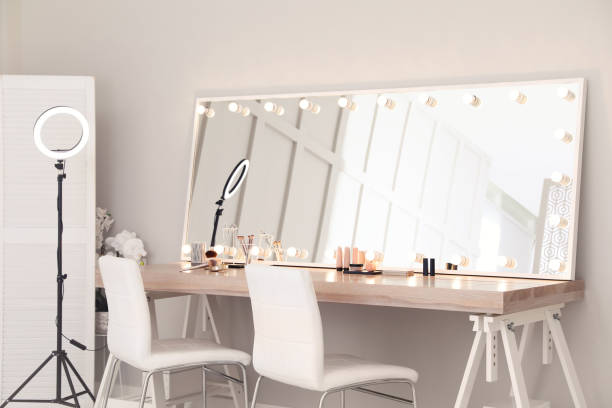 istock Modern mirror with light bulbs on dressing table in makeup room 1445742572