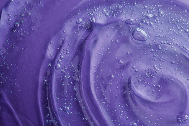 istock Transparent shower gel on violet background, closeup 1445742573