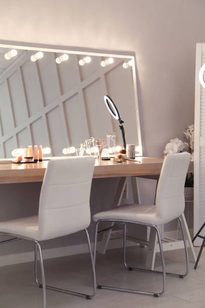istock Modern mirror with light bulbs on dressing table in makeup room 1445742640