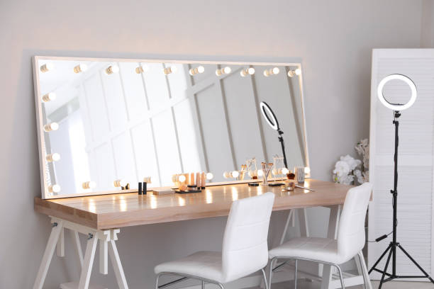 istock Modern mirror with light bulbs on dressing table in makeup room 1445743599