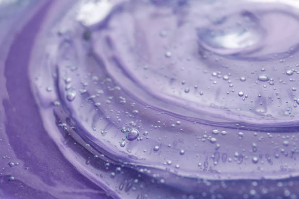 istock Transparent shower gel on violet background, closeup 1445744729