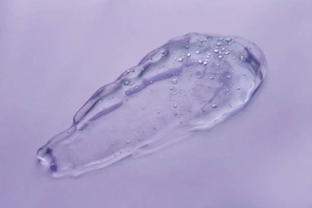istock Sample of transparent shower gel on violet background 1445744764