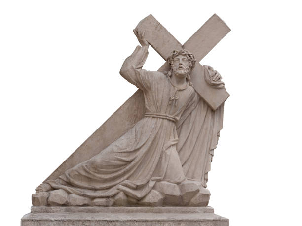The stone sculpture of suffering Jesus carrying a heavy cross isolated on the white background
