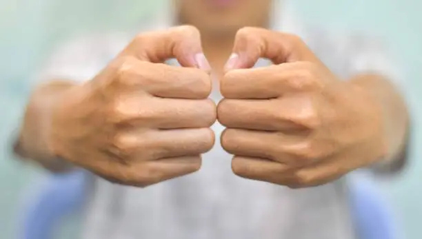 Hand of Southeast Asian elder man. Concept of rheumatoid arthritis, osteoarthritis, or joint pain.