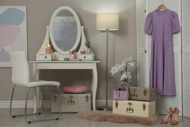 istock Stylish storage trunks, dressing table and beautiful orchid flower in room. Interior design 1445749152