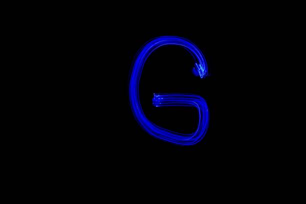istock Light painting blue letter G on black background 1445749257