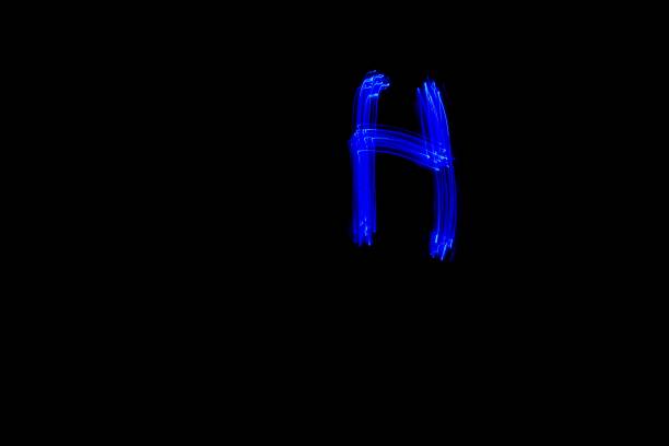 istock Light painting blue letter H on black background 1445749832