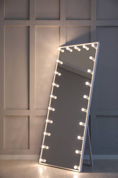 istock Modern mirror with light bulbs near molding wall in room 1445750637