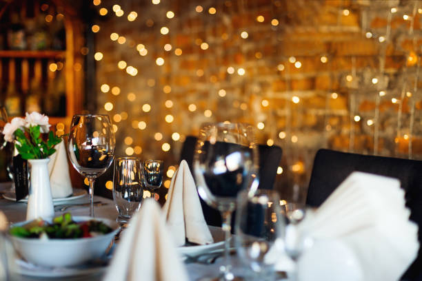 istock Wine glasses for different drinks on the table against the background of the wall with garlands 1445752565