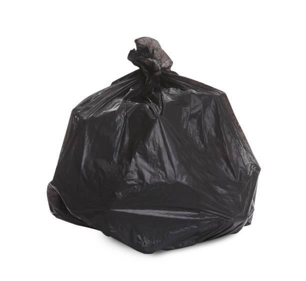 istock Black garbage bag full of trash on white background. Recycling rubbish 1445753338