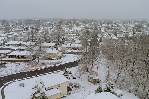 American small town located in New Jersey, USA, has house complex with a snow covered roof during the winter months when there is lot of snowfall