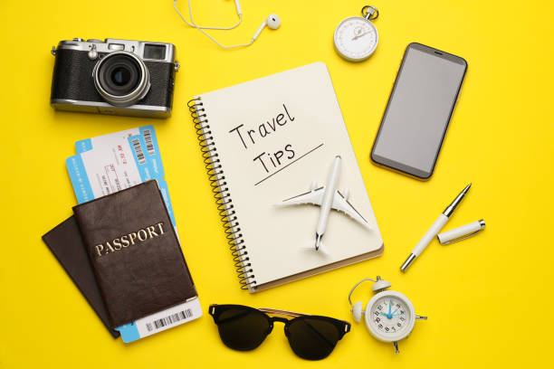 istock Flat lay composition with phrase Travel Tips written in notebook, passports, tickets and toy airplane on yellow background 1445753940