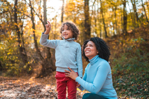 istock Hispanic Single Mother Bonding With Her Young Boy Outdoors In The Forest 1445757158