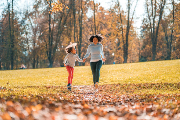 istock Active Hispanic Mother And Her Son Walking And Running In A Public Park 1445757164
