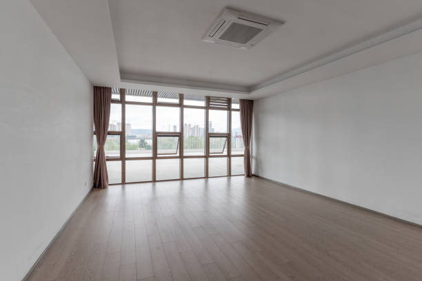 istock Empty room and modern urban buildings outside glass window 1445758644