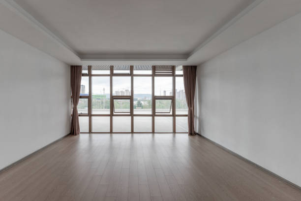 istock Empty room and modern urban buildings outside glass window 1445758657