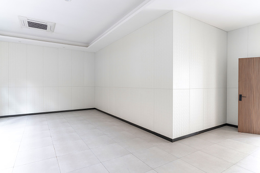 The wall and floor of an empty white room