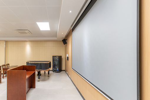 The podium and piano in the spacious and bright music classroom