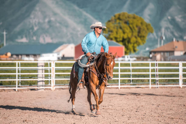 istock Cowboy Riding A Horse And Holding A Lasso 1445763844