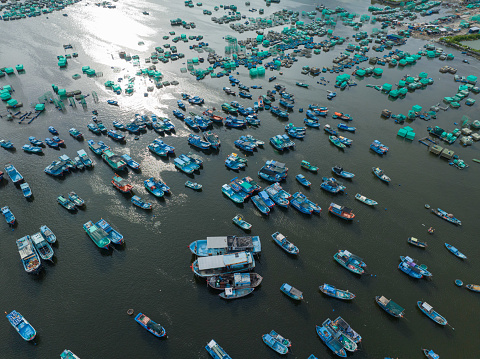 Drone view of fishing boats are nailing side by side for hiding tropical depression in Cam Ranh bay, Cam Ranh city, Khanh hoa province, central Vietnam