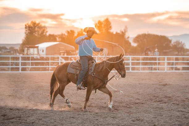 istock Cowboy Riding A Horse And Holding A Lasso 1445763939