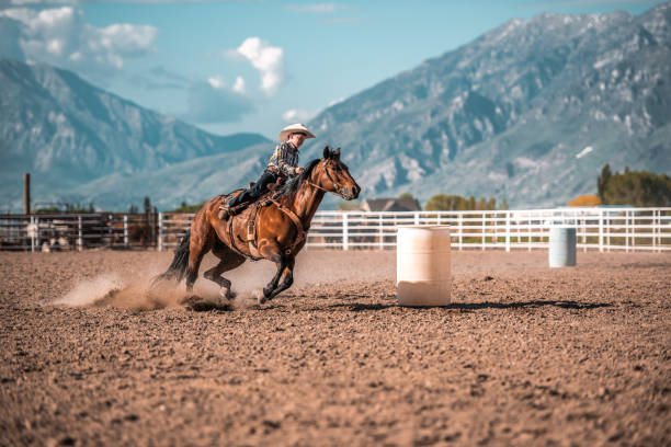 istock Young Cowboy Riding A Horse In A Rodeo Arena 1445764458
