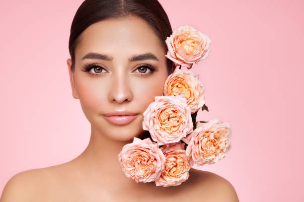 istock Beautiful young woman with a rose flower 1445764509