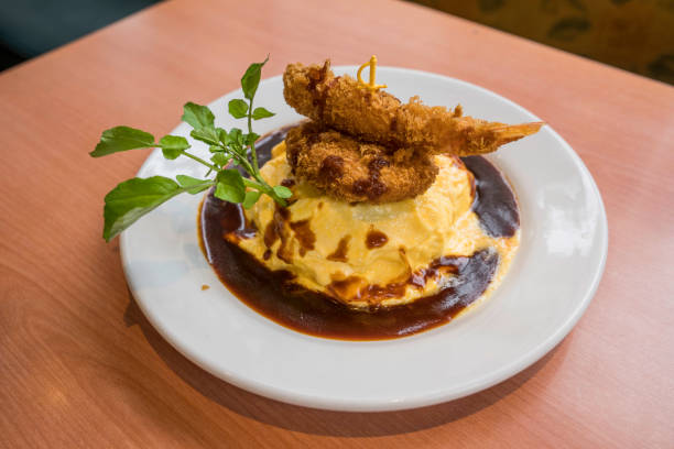 This image shows a mouth watering demi-glace egg omurice and tempura dish in japan.
