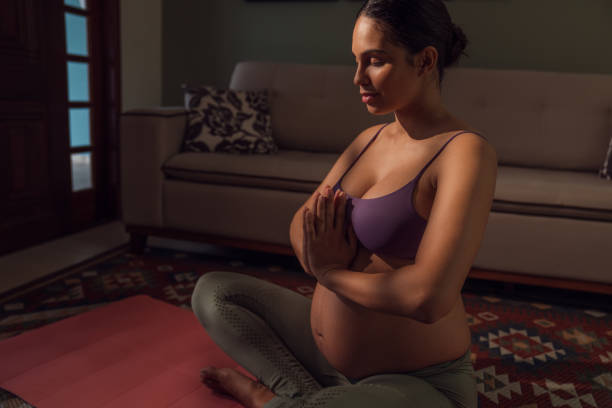 istock Young  expectant mother doing yoga at home 1445765536