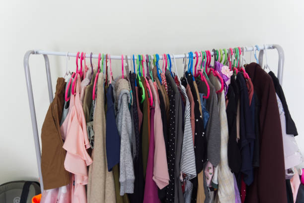 A clothesline was full of clothes hanging on it causing the curt A clothesline was full of clothes hanging on it causing the curtain rod to bend. clothes hanger rod stock pictures, royalty-free photos & images