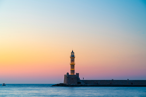 Chania Lighthouse on Chania, Crete, Greece, built in 1864 during sunset.