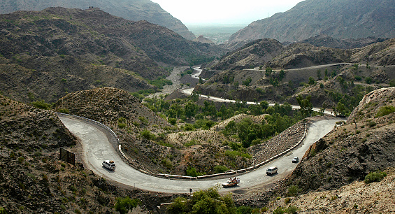 Khyber Pass, Peshawar, Khyber Pakhtunkhwa / Pakistan - Aug 16 2005: The Khyber Pass in northern Pakistan. Vehicles are climbing the Khyber Pass on the Pakistan side. The Khyber Pass is a vital road link from Peshawar, Pakistan to Landi Kotal and Torkham in Afghanistan