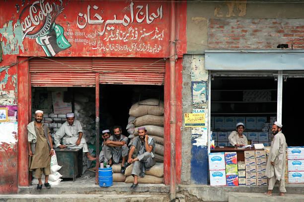 Local men outside two stores in Landi Kotal, Pakistan stock photo