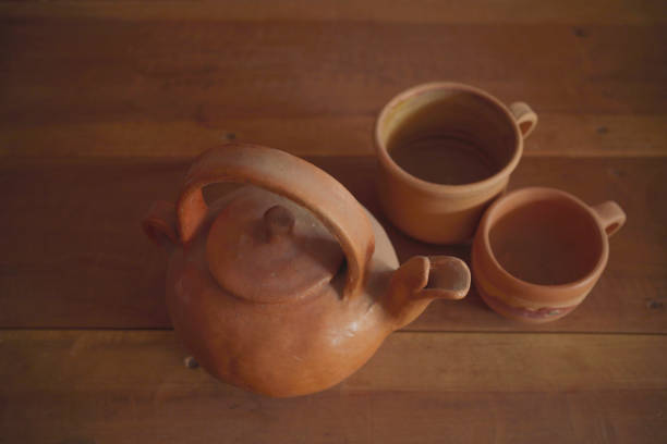 istock Earthenware kettle and mugs on wooden table background. 1445771279