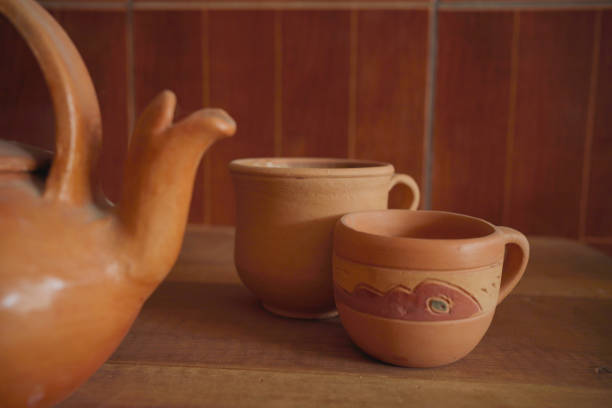 istock Earthenware kettle and mugs on wooden table. background. 1445771417
