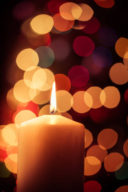 istock Burning Candle under Christmas Lights 1445771911